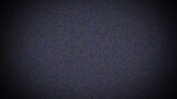 A grainy, dark background with a textured appearance, resembling noise or static