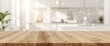 © AkuAku - Modern kitchen with a tidy, well-lit interior and an empty wooden table for showcasing products