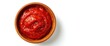 © AkuAku - Top view of a wooden bowl containing tasty tomato paste isolated on white