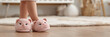 © tanya78 - a child's feet in soft slippers with ears on the floor in a room