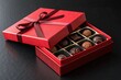 © Anastasiia Kasina - Red box of chocolate gift with ribbon isolated on black background