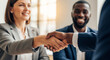 © Olga Ко - Smiling business woman shaking hands with african american candidate after successful job interview, close up of handshake.