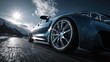 © Pavel - Modern car tire and alloy wheel on asphalt road under bright sun in a mountain setting during early afternoon