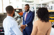 © Prostock-studio - Car Dealership Concept. Salesperson Handshaking With Young Black Customers Couple In Showroom, African American Spouses Buying New Automobile In Modern Auto Salon, Selective Focus On Manager