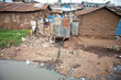 © Wollwerth Imagery - Fetid water and trash litter the landscape among mud buildings in Kibera, Kenya, the largest urban slum in Africa.