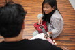 © airdone - Asian father teaching his young daughter how to play the ukulele at home