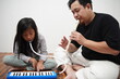 © airdone - Asian father teaching his young daughter how to play the melodica and recorder at home