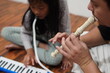 © airdone - Asian father teaching his young daughter how to play the melodica and recorder at home