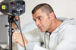 © auremar - photographer controlling the studio flash strobe lighting head