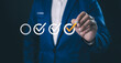 © Suriya - A business professional ensures quality control and successful task completion by making a selection on a digital check mark icon. verification, and goal achievement.check mark, strategic management,