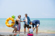© Thitiporn - Multi-generational Asian family enjoying summer beach vacation together. Grandparents, parents, and child bonding by the sea, joyful outdoor. family, beach, vacation, summer, multi-generational.