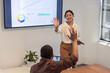 © wavebreak3 - Diverse coworkers analyzing data on display at conference room, tablet, laptop, plant, copy space