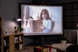 © Pixel-Shot - Interior of dark room with video projector screen. Home cinema