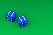 © klenger - Two blue dice rolling on green surface