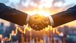 © Uang - Two people in suits shake hands, against a city and stock chart background