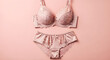 © Muhammad - Elegant pale pink satin and lace lingerie set featuring a comfortable push-up bra and matching briefs laid flat on a solid background.
