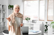 © Pixel-Shot - Portrait of young Muslim businesswoman in office