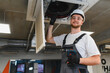 © Serhii - Hvac technician working on ceiling air conditioner unit