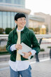 © Westend61 - Confident businesswoman smiling outdoors holding a digital tablet