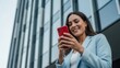 © Svyatoslav Lypynskyy - Woman using smartphone with modern building background