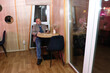 © Vasyl - Man sitting at a cafe table, holding a drink and looking aside in a cozy interior.