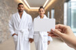 © Andrey_Lobachev - Gift certificate and gift card concept for a luxury spa salon with an elegant couple in white bathrobes, romantic wellness experience, premium voucher design for relaxation and couples services