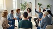 © dreamdes - Diverse group of men and women sitting in a circle during a support meeting. People participating in a therapy session for mental health support