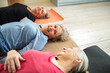 © Marko Geber - Three senior women relaxing on yoga mats indoors