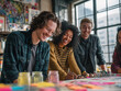 © SERGEI - A vibrant, dynamic shot of a small group of friends working on a creative project in a sun-drenched studio.