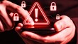 © igor.nazlo - Hands Holding Smartphone with Glowing Red Warning Triangles and Padlock. Cyber Security Alert, Phishing Attack and Malware Virus Concept. Mobile Data Breach and Hacking Risk Background.