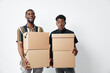 © SHOTPRIME STUDIO - Two young black men with dark skin holding cardboard boxes for moving or delivery. African ethnicity, casual clothing, isolated on white background with happy and surprised expressions.