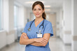 © dubogray1985 - A professional female nurse in modern medical uniform, standing confidently in a bright hospital corridor