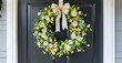 © antishock - Floral wreath hangs upon dark door. White, yellow blossoms create welcoming home accent. Simple ribbon adds delicate touch.