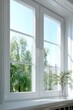 © Iryna - Sunlit white window frame overlooking green trees and potted plant