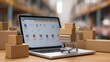 © Arfa_Media - Laptop displaying an online store with a mini shopping cart full of delivery boxes, representing online shopping and logistics