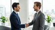 © Feri - Two businesspeople shaking hands in modern office