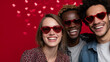 © Maksym - Multicultural friends posing joyfully in heart sunglasses, radiant red backdrop with glowing floating hearts, smiles and laughter emphasized, vibrant, energetic, and festive mood