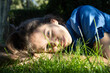 © Anna - close-up of beautiful teenage girl lying on green grass in sun's rays, enjoying moment. sweet young woman relaxes and dreams in the park. Spring, summer, sunbathing, filling up with nature's energy.