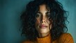 © rifai_art - Close-up of woman with dark curly hair, freckles, wearing an orange sweater, gazing