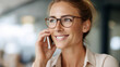 © Denis Yevtekhov - Faceless woman with glasses talking on phone in office looking away and smiling, business communication, workplace phone conversation, professional mobile call, defocused person, w