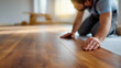 © Denis Yevtekhov - Faceless professional flooring contractor installing wooden floor in modern American home, hardwood installation service, residential flooring work, defocused worker, with copy spa