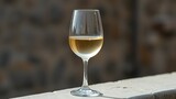 corretto. A clear glass of white wine on a stone ledge with condensation. bar promotions, beverage menus, designed for food & beverage menus and cafe branding, enhances appetite appeal.
