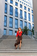 © Stanislav - Fashion meets minimalism as a woman poses on outdoor steps, evoking confidence, grace, and contemporary lifestyle.