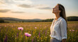 © Marin Studio - Woman breathing deeply in a field of flowers at sunset, feeling peaceful and serene