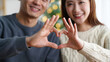 © olgakris - Couple forming heart shape with hands, bonding and affection concept, joyful romantic expression, happy togetherness moment, intimate connection and love gesture, smiling relationship satisfaction