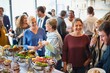 © Rawpixel.com - A diverse group of people enjoying a buffet at a social event. Smiling guests, diverse crowd, buffet food, and socializing in a lively atmosphere. Diverse people mingle at a social event.