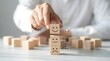 © CuteBee - Hand placing wooden smiley face blocks on table showing positive negative emotions for mental health and teamwork concept