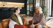 © Azeemud25/peopleimages.com - Relax, senior women and friends in home for conversation, gossip and bonding together on weekend. Elderly people, talking and chill in living room for catch up, story and reunion in retirement