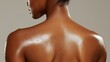 © Anucha - close-up view of a glistening, moisturized back, showcasing smooth skin with droplets of water, highlighting beauty and skin care.