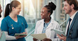 © peopleimages.com - Businessman, doctors and nurse with meeting in clinic for surgery funding, action plan or feedback. Medical chart, people and team with tech for resource allocation, hospital management and planning